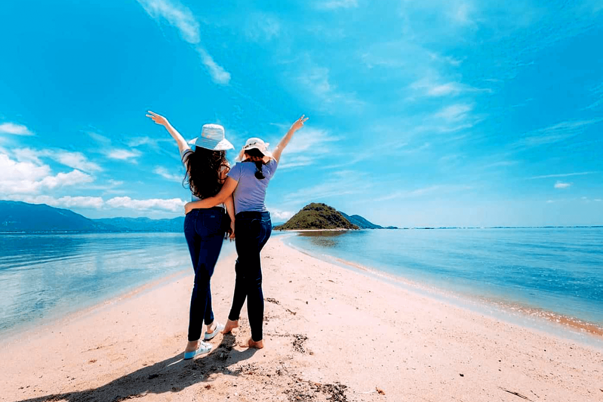 Sunshine and tourists enjoying Nha Trang beach in August
